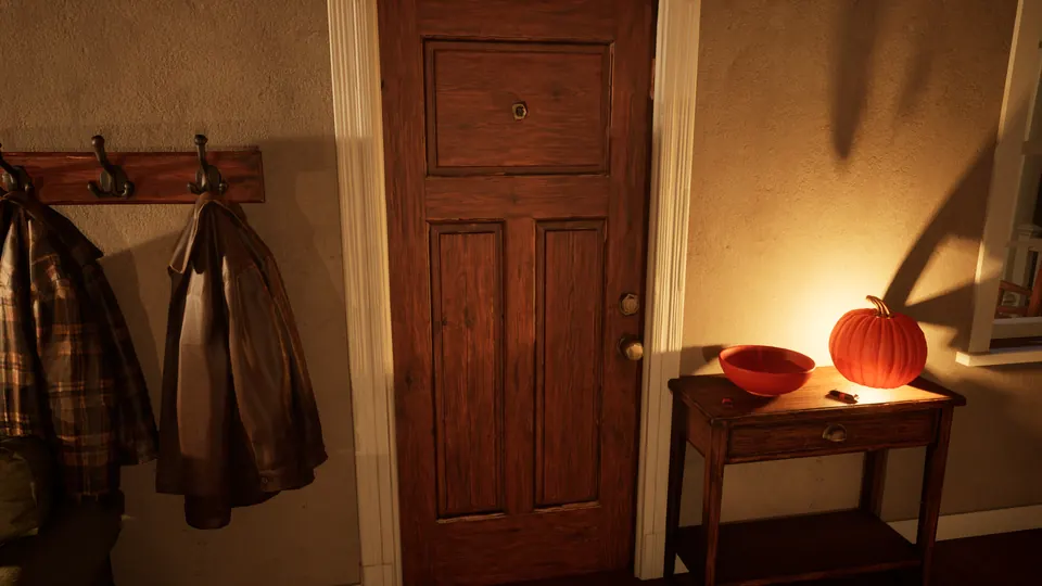 The closed front door from inside, with coats on hooks and a lit pumpkin on the entry table